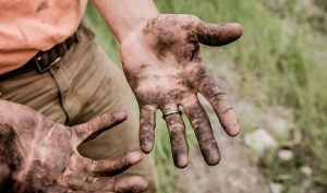 Hard worker displays dirty hands