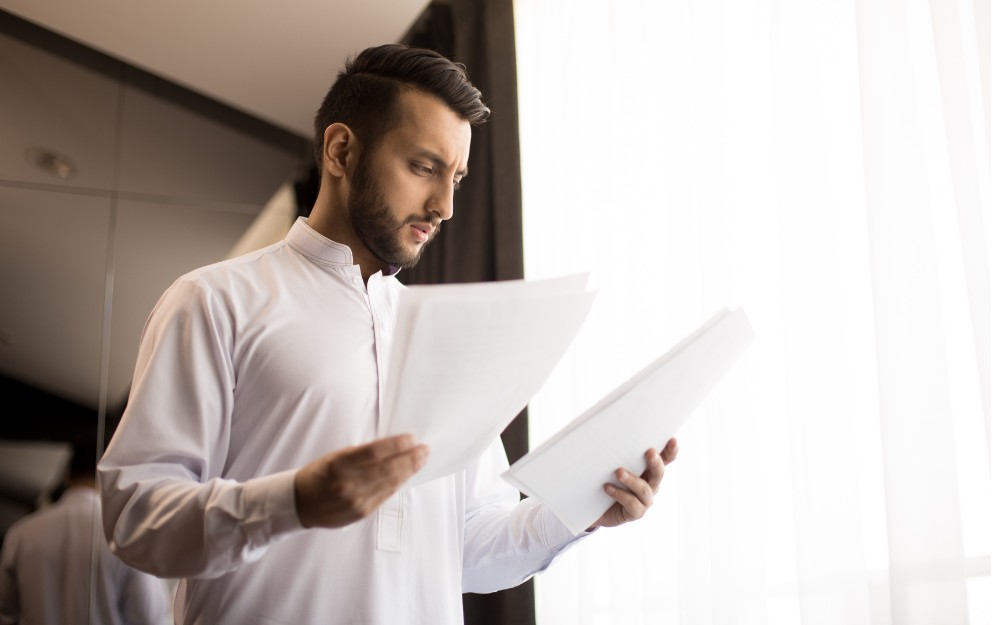 Man reading a NOA document, receiving a 0% whole person impairment assessment