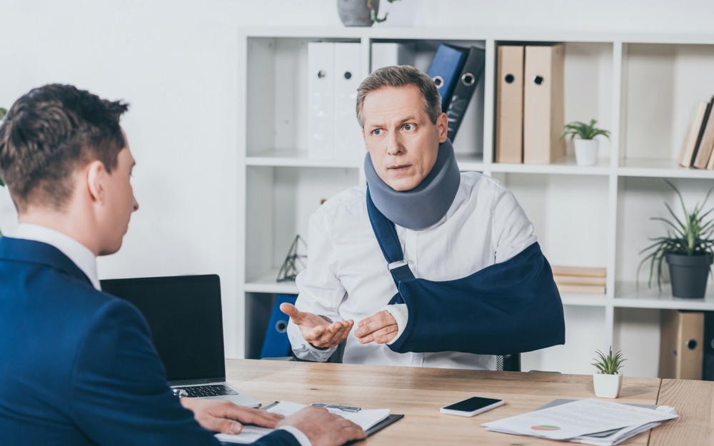 Man talking to a lawyer, Navigating Personal Injury Compensation Claims After Car Accidents in Queensland